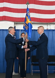 U.S. Air National Guard Lt. Col. Keith Walker, right, accepts the 174th Operations Group's guidon during a Change of Command ceremony held at Hancock Air National Guard Base on Jun 3, 2023. During a Change of Command ceremony, the guidon of the unit is passed from the former commander to the new commander, representing the transfer of responsibility. (U.S. Air National Guard photo by Master Sgt. Barbara Olney)