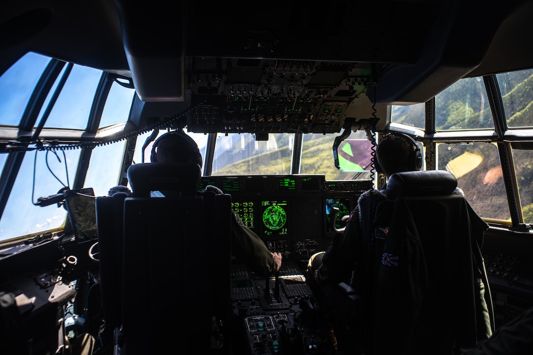 U.S. Marine Corps Maj. John Coutoumas a KC-130J Super Hercules aircraft pilot assigned to Marine Aerial Refueler Transport Squadron 153, left, and Capt. Kale Heckerson a KC-130J Super Hercules aircraft pilot assigned to VMGR-152, right, conduct threat reaction maneuvering training during exercise Kodiak Mace 23, Alaska, May 25, 2023. Marines with VMGR-153, VMGR-152, and VMGR-234 travelled from Hawaii, Texas, and Japan to increase combat readiness and sharpen tactical skills during joint training exercise Kodiak Mace 23 in Alaska’s unique environment.