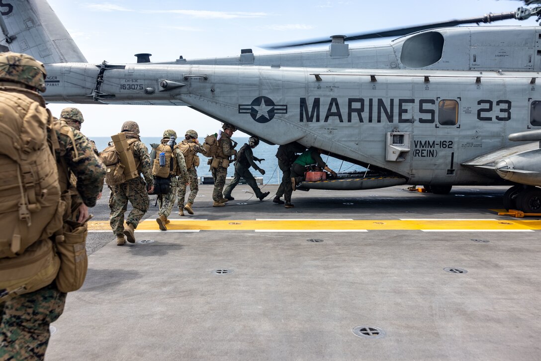 U.S. Marines with the 26th Marine Expeditionary Unit load into a CH-53E Super Stallion aboard the Wasp-class amphibious assault ship USS Bataan (LHD 5) prior to conducting a scenario-driven foreign humanitarian assistance (FHA) during Composite Training Unit Exercise, Atlantic Ocean, May 24, 2023. FHA consists of Department of Defense activities conducted outside of the U.S. and its territories to directly relieve or reduce human suffering, disease, hunger, or privation. FHA is intended to supplement or complement efforts of host nation civil authorities or agencies with the primary responsibility for providing assistance. The 26th Marine Expeditionary Unit serves as one of the Nation’s premier crisis response forces capable of conducting amphibious operations, crisis response, and limited contingency operations, to include enabling follow-on forces and special operations.