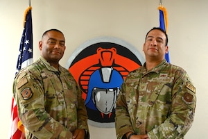 Master Sgt. Francisco Garrigas, 7th Aircraft Maintenance Squadron support section chief, and Tech. Sgt. Luis Garrigas, 7th Equipment Maintenance Squadron assistant first sergeant, pose for a photo at Dyess Air Force Base, Texas, May 24, 2023. Both are brothers stationed together at Dyess in the nondestructive inspection career field. (U.S. Air Force photo by Airman 1st Class Emma Anderson)
