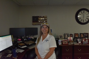 Beth Clements sits at her desk in the Unite Program Office on Sheppard AFB.