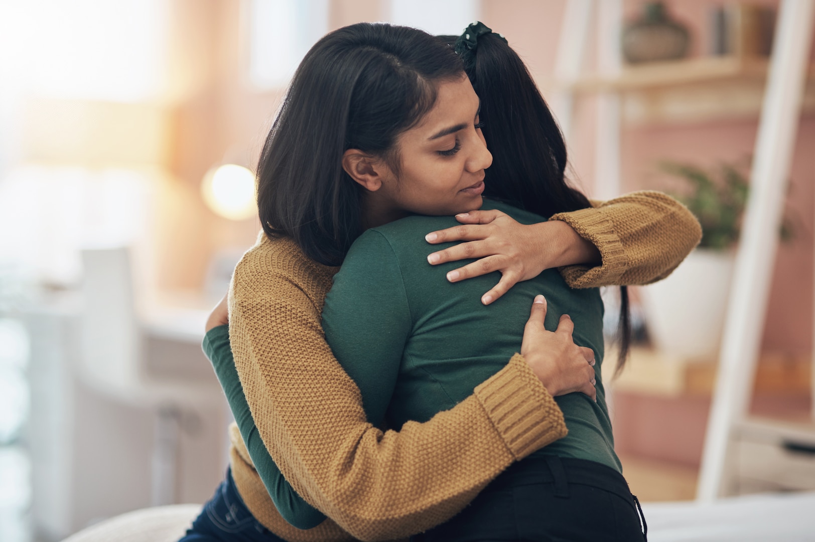 Two women hugging.