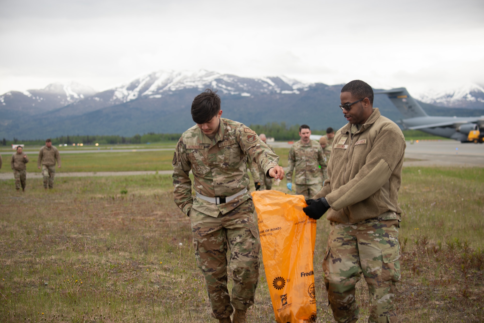 U.S. Airmen assigned to the 3rd Wing conduct a foreign object and debris walk at Joint Base Elmendorf-Richardson, Alaska, June 2, 2023. The Airmen conducted the FOD walk to remove debris that could potentially damage aircraft and hinder mission readiness.