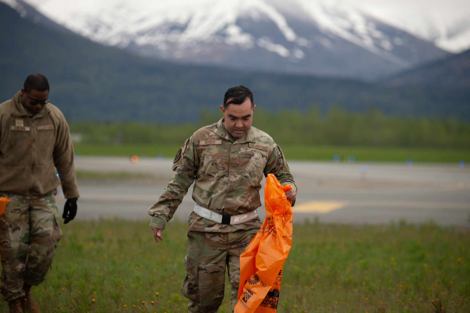 U.S. Airmen assigned to the 3rd Wing conduct a foreign object and debris walk at Joint Base Elmendorf-Richardson, Alaska, June 2, 2023. The Airmen conducted the FOD walk to remove debris that could potentially damage aircraft and hinder mission readiness.