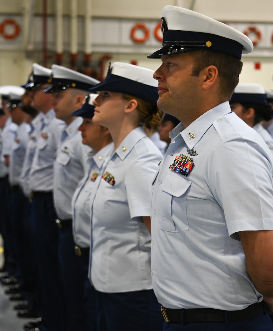 Coast Guard Base Kodiak personnel stand at parade rest during a change-of-command ceremony in Kodiak, Alaska, June 6, 2023. Base Kodiak is the largest land installation of the Coast Guard and serves as the senior Mission Support touchstone for Coast Guard operations within the 17th District across Alaska, standing shoulder-to-shoulder with its operational partners to ensure the delivery of professional, responsive and cost-effective services to the American public. U.S. Coast Guard photo by Petty Officer 3rd Class Ian Gray.