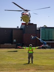 Mike Koegal, an operations leader for King County Search and Rescue, directs an MH-60 Seahawk helicopter, assigned to Naval Air Station Whidbey Island's Search and Rescue, to land at Naval Station Everett (NSE), June 6, 2023. NSE participated in a regional aircraft emergency response training exercise that includes aircraft and first responders from state, county, and local partner agencies in the Northwest Regional Aviation consortium. The training focuses on preparing for a potential real-world earthquake and tsunami disaster response. The exercise will help participating organizations, including the Navy, improve their ability to work together to support local emergency responders in a large-scale organized response. (U.S. Navy photo by Mass Communication Specialist 2nd Class Ethan Soto)