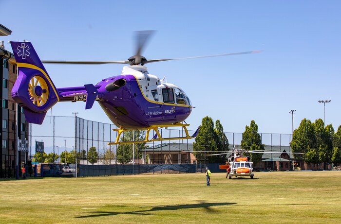 An MH-60 Seahawk helicopter, assigned to Naval Air Station Whidbey Island's Search and Rescue, and a LifeFlight helicopter take off from Naval Station Everett (NSE), June 6, 2023. NSE participated in a regional aircraft emergency response training exercise that includes aircraft and first responders from state, county, and local partner agencies in the Northwest Regional Aviation consortium. The training focuses on preparing for a potential real-world earthquake and tsunami disaster response. The exercise will help participating organizations, including the Navy, improve their ability to work together to support local emergency responders in a large-scale organized response. (U.S. Navy photo by Mass Communication Specialist 2nd Class Ethan Soto)
