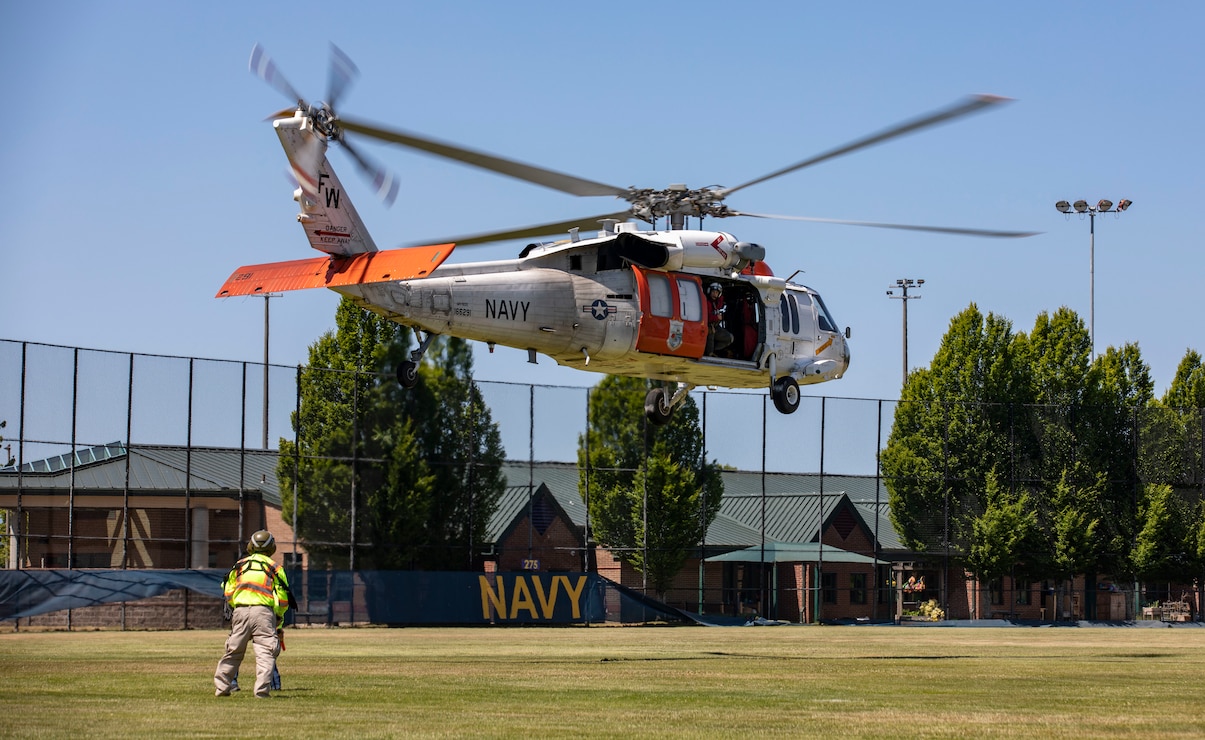 An MH-60 Seahawk helicopter, assigned to Naval Air Station Whidbey Island's Search and Rescue, takes off from Naval Station Everett (NSE), June 6, 2023. NSE participated in a regional aircraft emergency response training exercise that includes aircraft and first responders from state, county, and local partner agencies in the Northwest Regional Aviation consortium. The training focuses on preparing for a potential real-world earthquake and tsunami disaster response. The exercise will help participating organizations, including the Navy, improve their ability to work together to support local emergency responders in a large-scale organized response. (U.S. Navy photo by Mass Communication Specialist 2nd Class Ethan Soto)