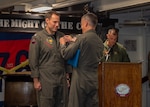 Capt. Brennan Sweeney, commander, Carrier Air Wing 5, awards a meritorious service medal to Cmdr. Jonathan Dorsey, commanding officer of Helicopter Sea Combat Squadron (HSC) 12, during a change of command ceremony in the fo’c’sle of the U.S. Navy’s only forward-deployed aircraft carrier, USS Ronald Reagan (CVN 76), in the North Pacific Ocean, June 1, 2023. During the change of command, Dorsey was relieved by Cmdr. Seth Saalfeld as commanding officer of HSC 12. HSC 12, originally established as Helicopter Anti-Submarine Squadron (HS) 2 on March 7, 1952, is the oldest active operational Navy helicopter squadron. Ronald Reagan, the flagship of Carrier Strike Group 5, provides a combat-ready force that protects and defends the United States, and supports alliances, partnerships and collective maritime interests in the Indo-Pacific region.