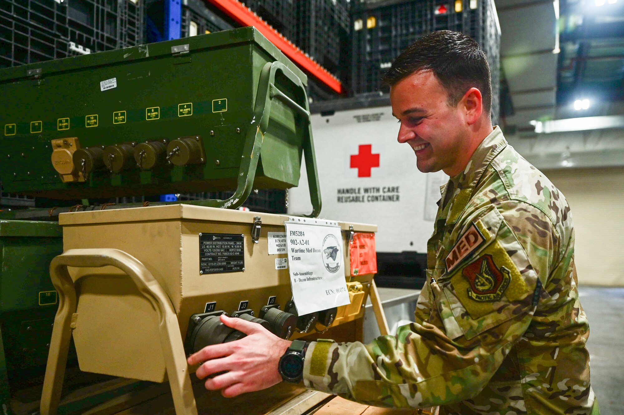 Tech. Sgt. Shane Borodycia performs a cannon plug during a power distribution panel demonstration, at Kunsan Air Base