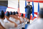 U.S. Air Force Maj. Gen. Clark Quinn, 19th Air Force commander, renders his first salute to the unit formation during the 19th AF assumption of command ceremony