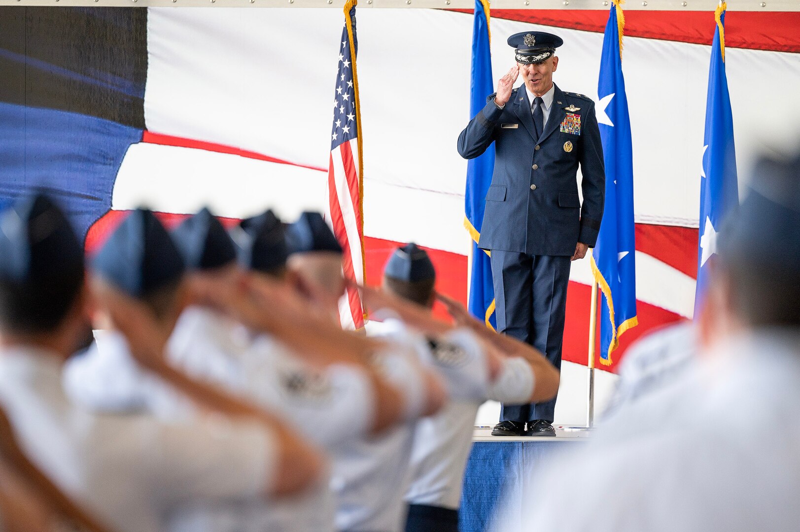 U.S. Air Force Maj. Gen. Clark Quinn, 19th Air Force commander, renders his first salute to the unit formation during the 19th AF assumption of command ceremony