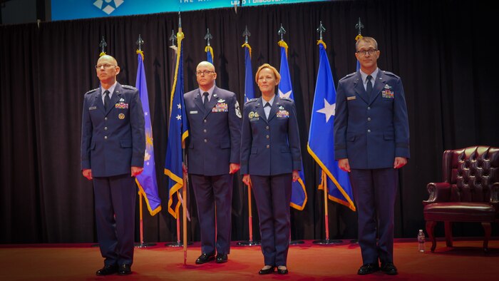 Maj. Gen. Heather L. Pringle, left, and Brig. Gen. Scott A. Cain, right, listen to remarks from Gen. Duke Z. Richardson, commander, Air Force Materiel Command, during a change of command ceremony for the Air Force Research Laboratory, or AFRL, where Pringle relinquishes command to Cain, while Chief Master Sgt. Bill Fitch, AFRL command chief, stands behind them at the National Museum of the U.S Air Force, June 5, 2023. Cain was chosen to be the 13th commander of AFRL and said he looks forward to the new position. He previously served as director of Air, Space and Cyberspace Operations at Headquarters, Air Force Materiel Command. (U.S. Air Force photo / Keith Lewis)