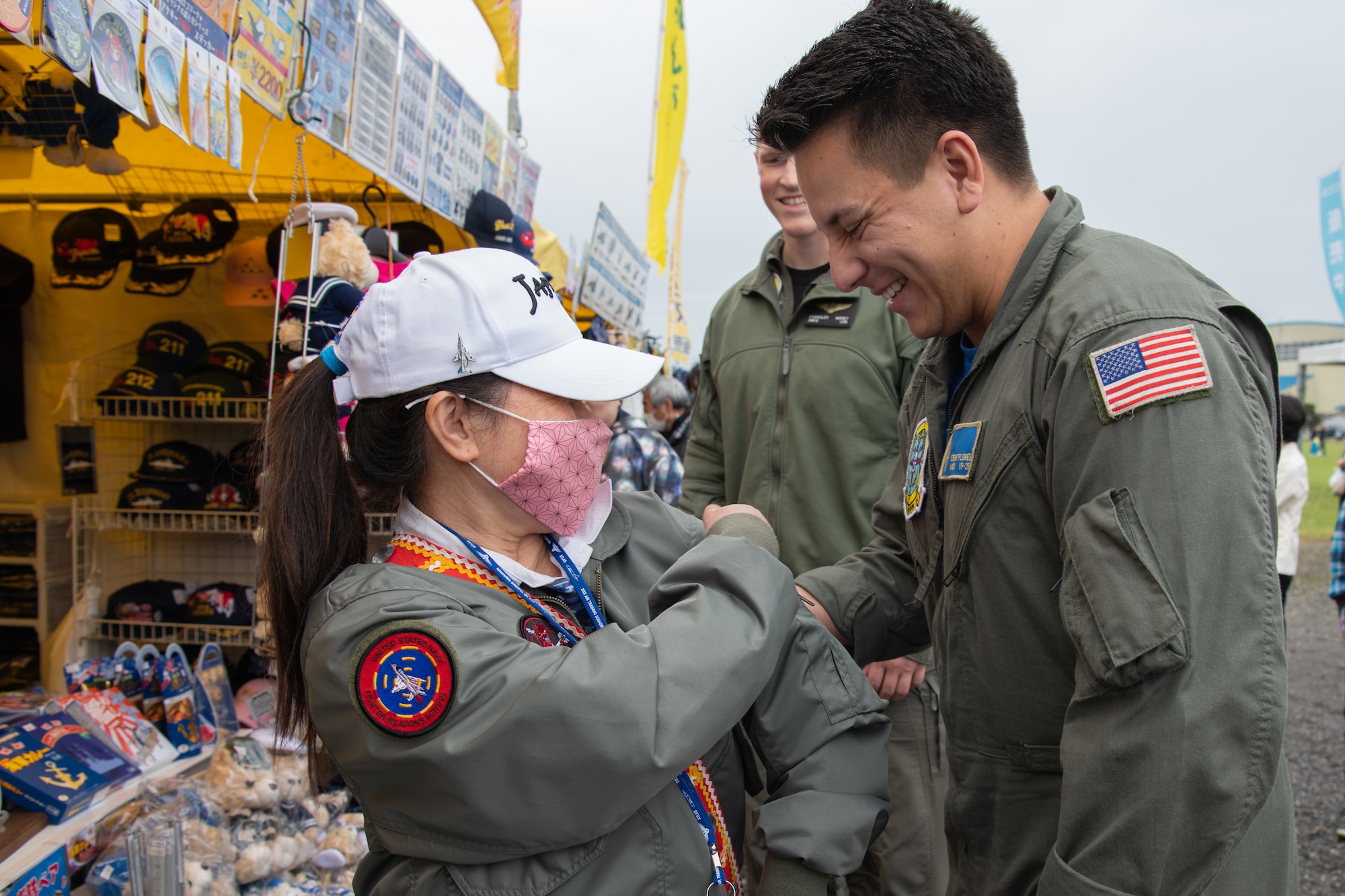 A member of the Japanese local community shows off a patch to a member of the 319th Expeditionary Reconnaissance Squadron at an Air Memorial event at Japan Maritime Self-Defense Force Kanoya Air Base, April 30, 2023. This was the first Air Memorial in Kanoya to include the 319th ERS. Japanese and U.S. service members expressed excitement about collaborating in this event and expressed appreciation for mutual exchanges of knowledge and experience. (U.S. Air Force photo by Senior Airman Brooklyn Golightly)