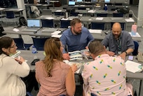 Troy Furlow (center) is the site director at the Dülmen Army Prepositioned Stocks-2 worksite. He signed up for U.S. Army Sustainment Command’s Journey to Leadership program and said JLT has proven very beneficial. Pictured here, Furlow works with his JLT small group at Rock Island, Illinois, during one of the week-long training sessions. (U.S. Army courtesy photo)