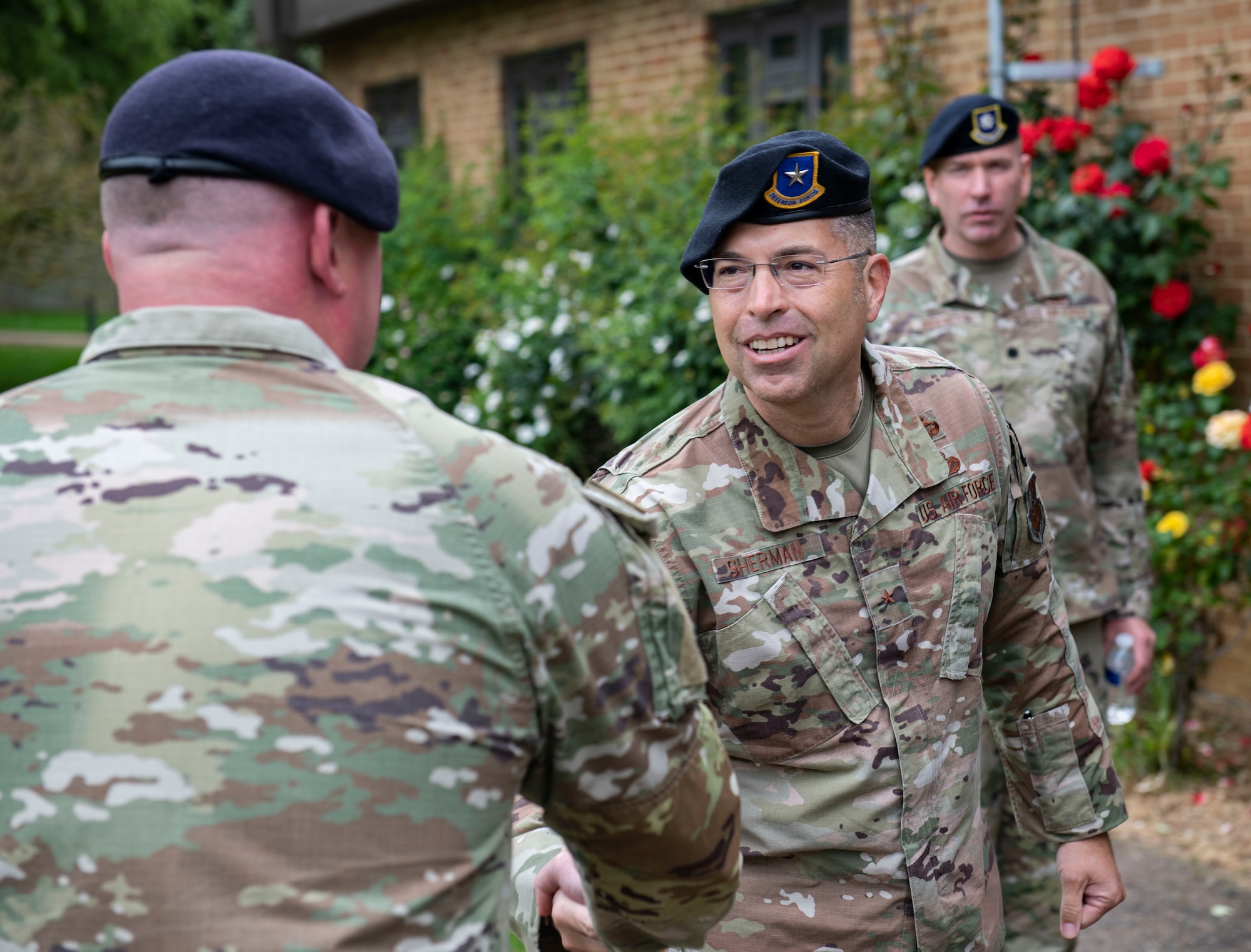 Brig. Gen. Thomas Sherman, U.S. Air Force director of security forces, shakes hands with an Airman from the 422d Security Forces Squadron at RAF Croughton