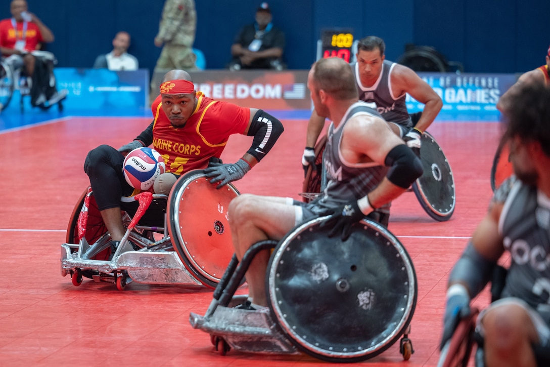 Multiple players compete in a rugby wheelchair match.