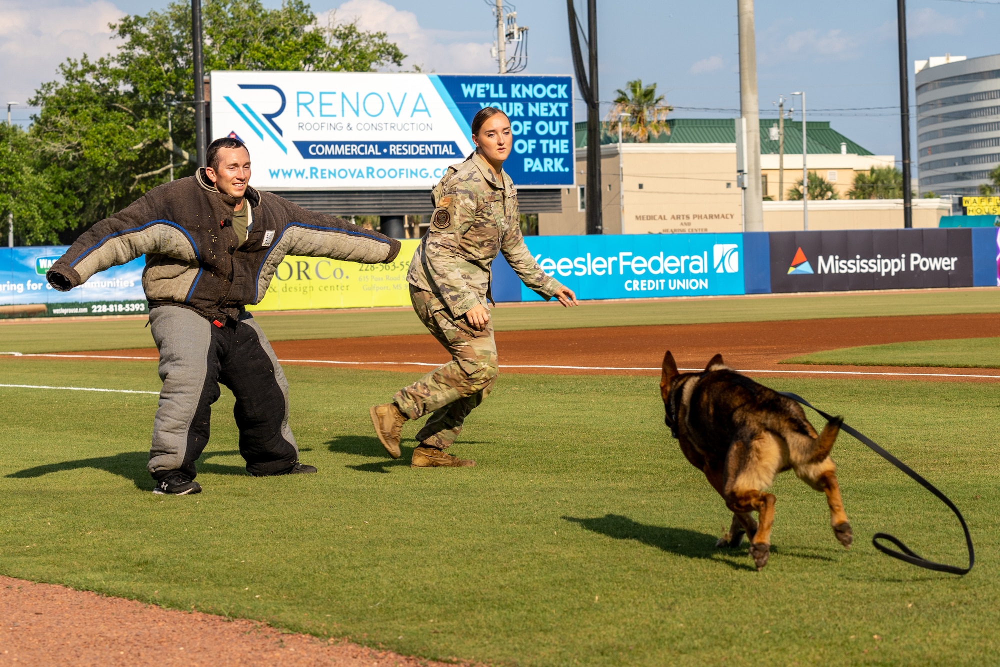 U.S. Air Force Staff Sgt. Dustin Hadsock, 81st SFS military working dog handler, Staff Sgt. Tessa Spare, 81st SFS MWD trainer, and Rico, 81st Security Forces Squadron MWD, perform a MWD demonstration at MGM Park, Biloxi, Mississippi, June 3, 2023.
