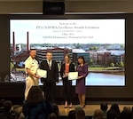 Naval Sea Systems (NAVSEA) Commander Vice Adm. Bill Galinis (far left) and NAVSEA Executive Director Giao Phan (far right) present Nicolas Bonowski and Melissa Cohen of the Naval Surface Warfare Center, Philadelphia Division’s (NSWCPD) Indefinite Delivery Indefinite Quantity (IDIQ) Team with the Excellence in Contract Management Award during the Fiscal Year 2022 Naval Sea Systems Command Excellence Awards on May 4, 2023. Fellow NSWCPD Alaina Farooq (IDIQ) Team member was unable to attend the ceremony. (U.S. Navy screenshot by Joseph Fontanazza/Released)
