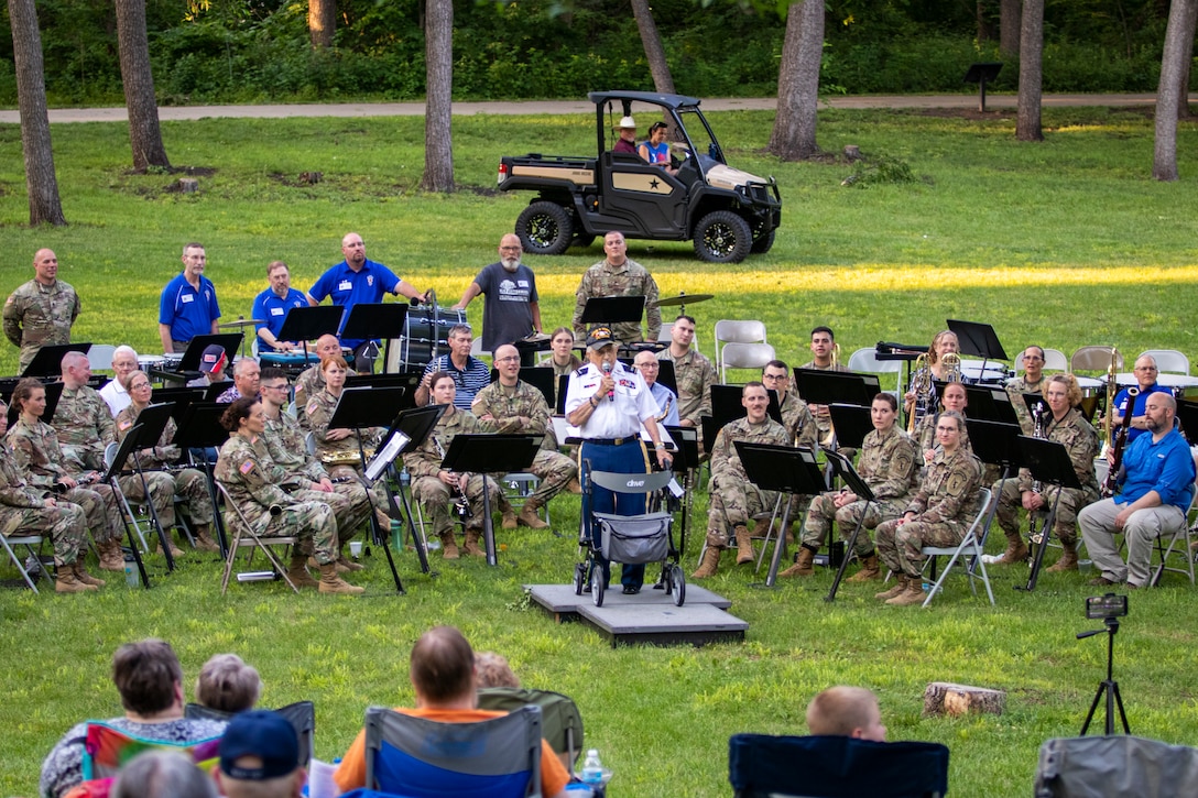 Retired Chief Warrant Officer 4 William Splichal, 99-years-old, conducts the Nebraska National Guard's 43rd Army Band Soldiers and alumni through John Philip Sousa's Golden Jubilee, during a 75th anniversary concert, June 3, 2023, at the Wildewood Park in Ralston, Nebraska.