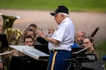 Retired Chief Warrant Officer 4 William Splichal, 99-years-old, conducts the Nebraska National Guard's 43rd Army Band Soldiers and alumni through John Philip Sousa's Golden Jubilee, during a 75th anniversary concert, June 3, 2023, at the Wildewood Park in Ralston, Nebraska. The Nebraska Army National Guard's 43rd Army Band celebrated 75 years of service with the anniversary concert, inviting alumni of the band to join with current members to perform a variety of songs, including many patriotic numbers. Splichal, a former bandmaster for the unit since it's inception, and who served during World War II and the Korean War, traveled from Texas for the 75th anniversary event. (U.S. Army National Guard photo by Staff Sgt. Lisa Crawford)