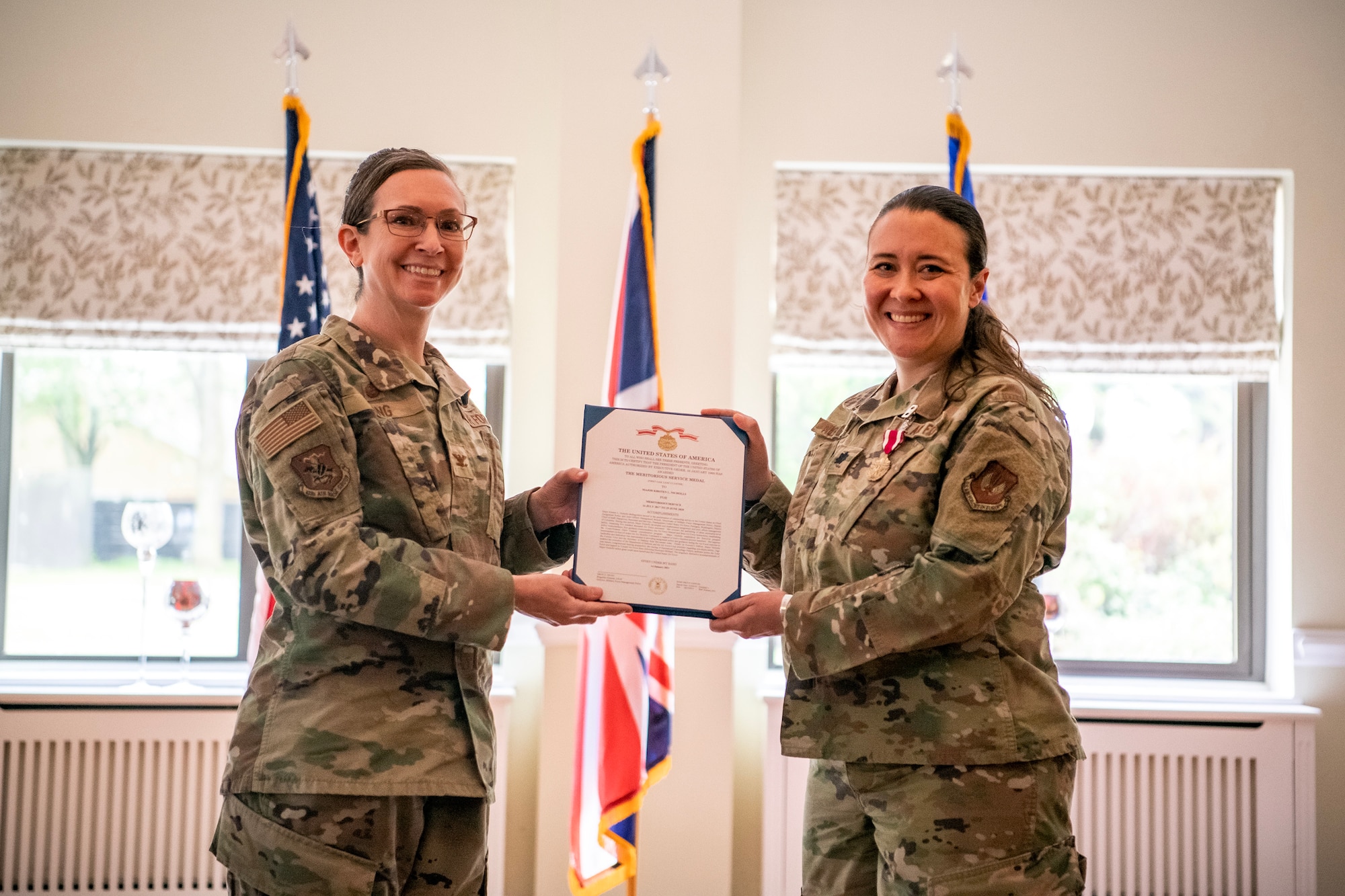U.S. Air Force Col. Valarie Long, left, 423d Air Base Group commander, presents a Meritorious Service Medal decoration to Lt. Col. Kirsten Nicholls, 423d Force Support Squadron outgoing commander, at RAF Alconbury, England, June 5, 2023. During her command Nicholls implemented quality of life programs for 32 facilities across two installations. Her activities also served 12 joint force and multi-national mission partners. (U.S. Air Force photo by Staff Sgt. Eugene Oliver)