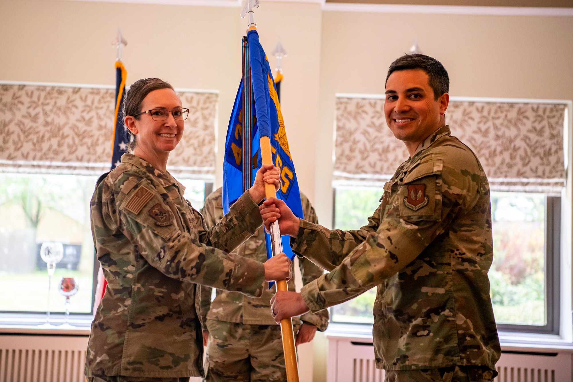 U.S. Air Force Maj. Roy Surita, right, 423d Force Support Squadron incoming commander, receives the 423d FSS guidon from Col. Valarie Long, 423d Air Base Group commander, during a change of command ceremony at RAF Alconbury, England, June 5, 2023. Prior to assuming command, Surita served as the Chief Officer of Force Development Policy at Headquarters U.S. Air Force, the Pentagon, Arlington, Virginia. (U.S. Air Force photo by Staff Sgt. Eugene Oliver)