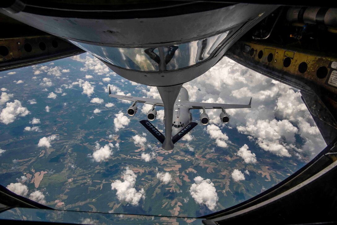 An aircraft receives fuel midair.