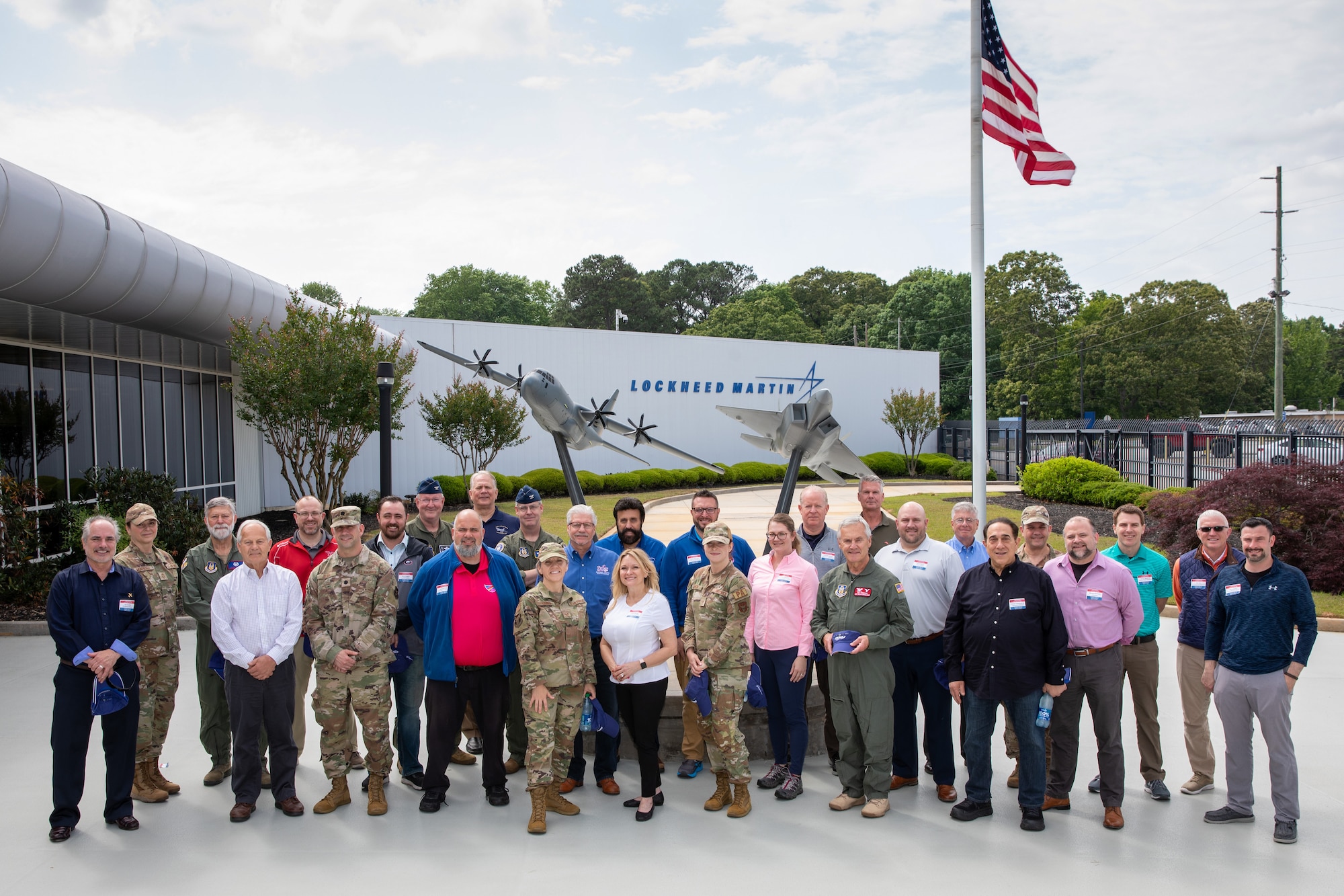 Participants in the 910th Airlift Wing’s civic leader tour to Dobbins Air Reserve Base, Georgia, pose for a photo in front of the Lockheed-Martin plant where they toured the new C-130J Super Hercules aircraft assembly line, May 11, 2023.