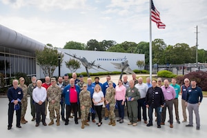 Participants in the 910th Airlift Wing’s civic leader tour to Dobbins Air Reserve Base, Georgia, pose for a photo in front of the Lockheed-Martin plant where they toured the new C-130J Super Hercules aircraft assembly line, May 11, 2023.