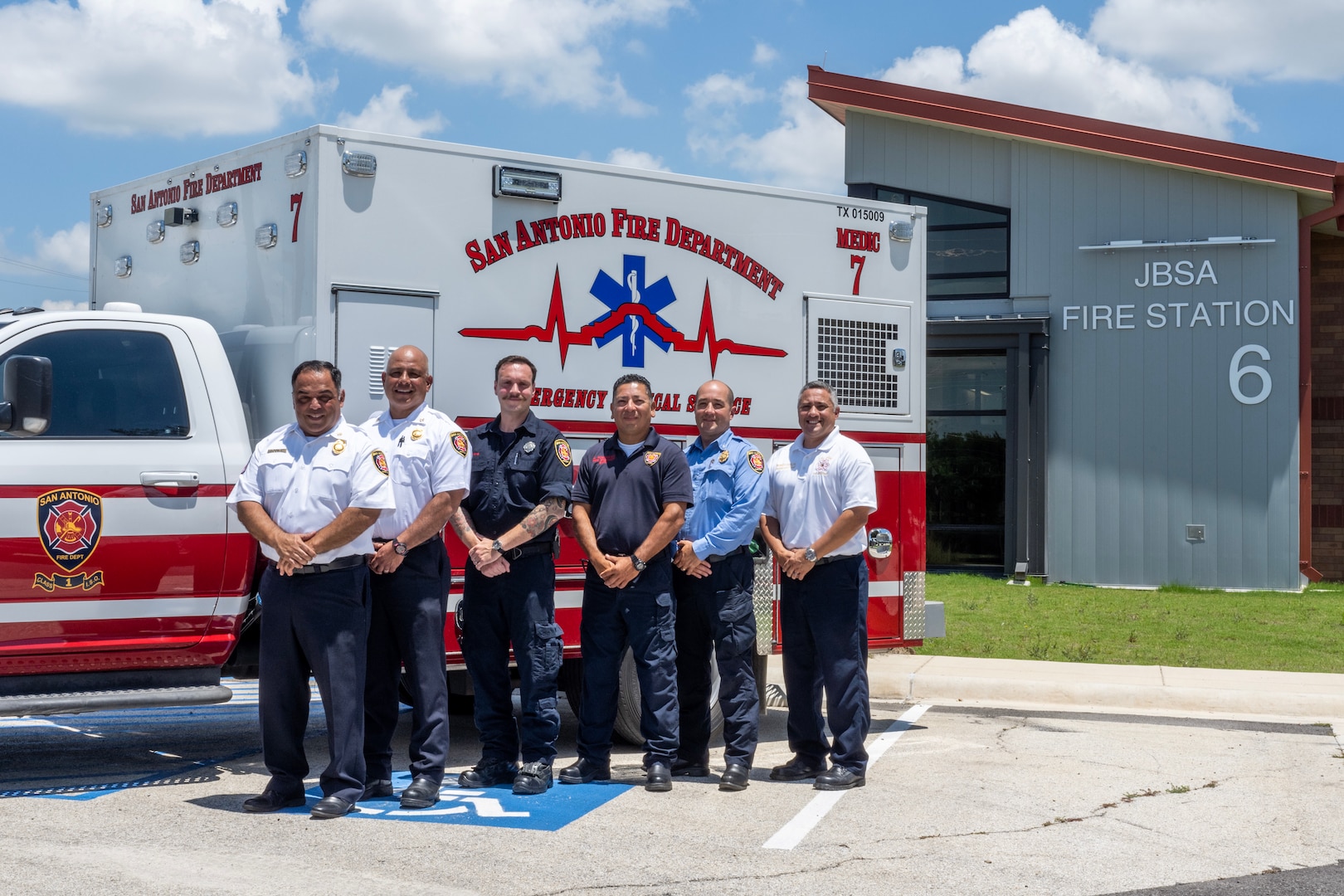 EMS personnel standing in front of ambulance.