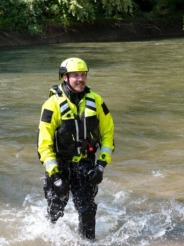 A Wright-Patt firefighter steps out of the water.