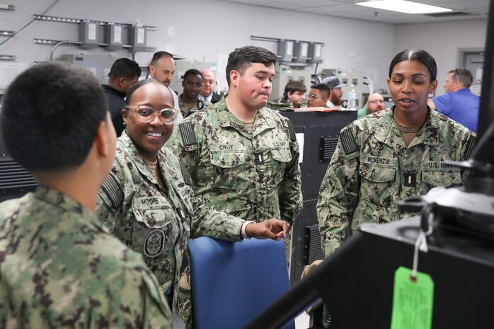 U.S. Navy Sailors attached to USS Fitzgerald (DDG 62), including (from left) Chief Petty Officer Nelli Gray-Diaz, Chief Petty Officer Clarissa Moore, Ensign Alexander Cruz, and Ensign Ariana McKenzie, speak about the Integrated Bridge Navigation System (IBNS) at Naval Surface Warfare Center, Philadelphia Division (NSWCPD) on May 15, 2023. (U.S. Navy photo by Sgt. Jermaine Sullivan/Released)