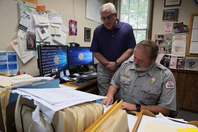 Scott Payne, sitting, Supervisory Park Ranger, and Mark Dean, Operations Project Manager, discuss budget issues in the Project Management Office at Okatibbee Lake, Mississippi, May 31, 2023. Dean has been working for the U.S. Army Corps of Engineers since 1985 and has been Project Manager since 2012.