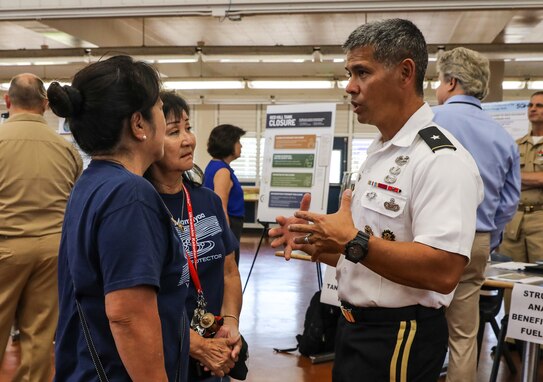 Joint Task Force-Red Hill (JTF-RH) Strategic Engagement Director, U.S. Army Brig. Gen. Lance Okamura, talks with local residents during an open house hosted by the Hawaii Department of Health at Moanalua High School, Honolulu, Hawaii, June 5, 2023.