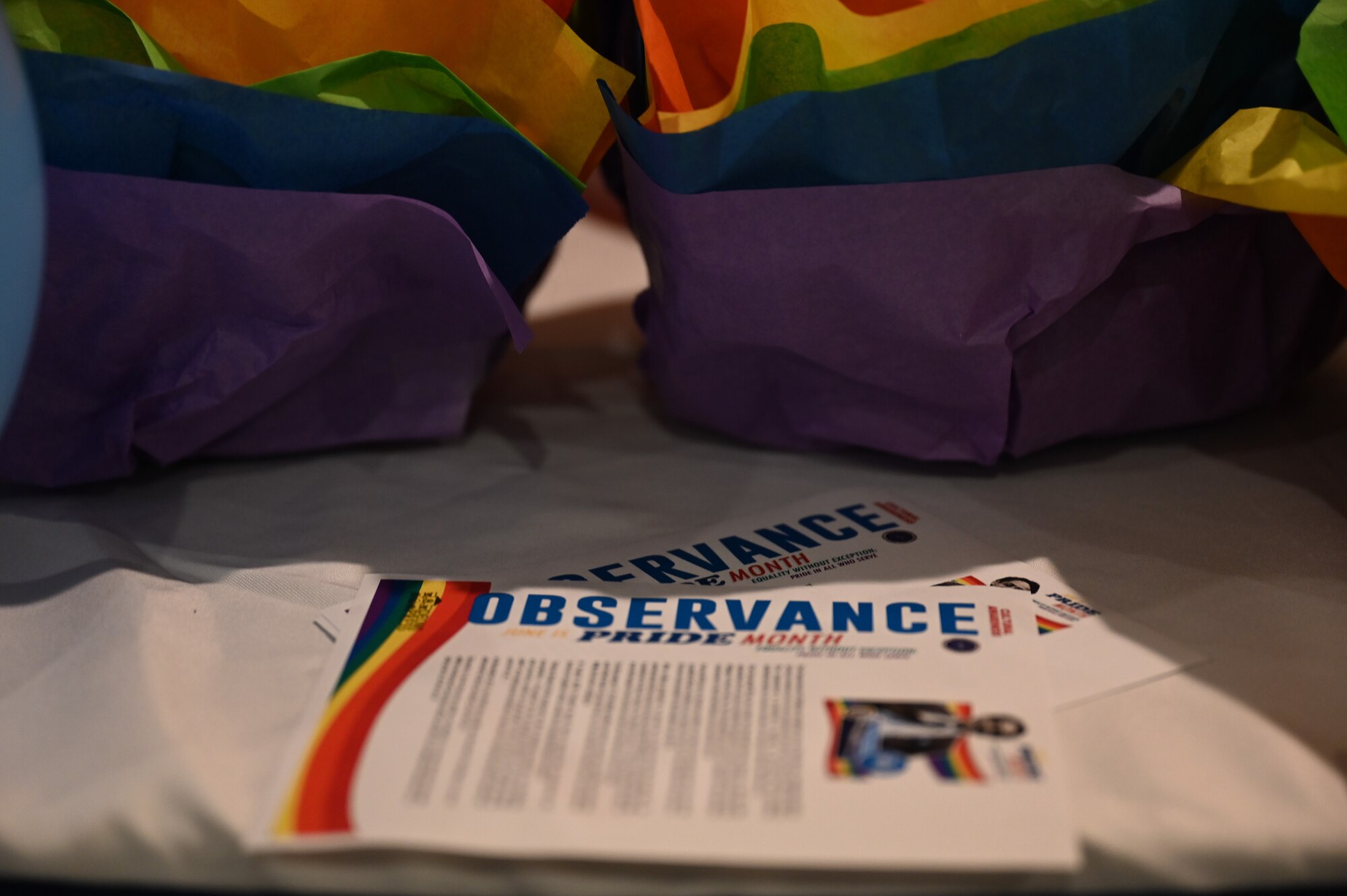A Pride Month observance flier is displayed on a table during the keynote speaker event held at Altus Air Force Base, Oklahoma, June 5, 2023. The event was held to showcase the stories and perspectives of U.S. Space Force Lt. Col Bree Fram, astronautical engineer, as one of the highest ranking, openly transgender officers in the U.S. military. (U.S. Air Force photo by Airman 1st Class Heidi Bucins).