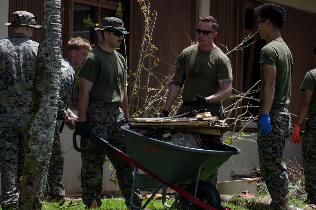 U.S. Marines assigned to the Marine Aviation Logistics Squadron – Forward, Marine Corps Air Station Miramar, California,, clean up debris after Typhoon Mawar at Andersen Air Force Base, Guam, June 2, 2023. Typhoon Mawar was a category four storm, producing winds of at least 130 mph (209 km) making it one of the strongest typhoons to hit Guam in decades. (U.S. Air Force photo by Airman 1st Class Emily Saxton)