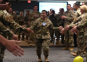 U.S. Air Force Master Sgt. select Jody McFarland, 17th Contracting Squadron section chief, runs through a crowd of supporters during a master sergeant release party at the Powell Event Center, Goodfellow Air Force Base, Texas, June 7, 2023. Coworkers and family members congratulated the selectees before they received their certificates. (U.S. Air Force photo by Airman 1st Class Zach Heimbuch)