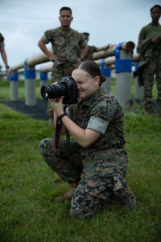 U.S. Marine Corps Lance Cpl. Courtney A. Robertson, a combat photographer with Combat Logistics Regiment 37, 3d Marine Logistics Group, takes photos of a tug o’ war event during a field meet on Marine Corps Air Station Futenma, Okinawa, Japan Oct. 22, 2021. Marines with Service Co. compete with teams in various physical events to build camaraderie, morale and physical fitness. 3d MLG, based out of Okinawa, Japan, is a forward deployed combat unit that serves as III MEF’s comprehensive logistics and combat service support backbone for operations throughout the Indo-Pacific area of responsibility. (U.S. Marine Corps photo by Lance Cpl. Sebastian Riveraaponte)
