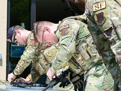 Members of the 113th Security Forces Squadron, 113th Wing DC Air National Guard, competed in a circuit of skills and fitness tests during May's drill weekend to cap off National Police Week on Joint Base Andrews in Md.
Participants vied for the best time while completing tasks like disassembling an M4 rifle, running with ammo cans, and performing baton strikes while answering snap questions.