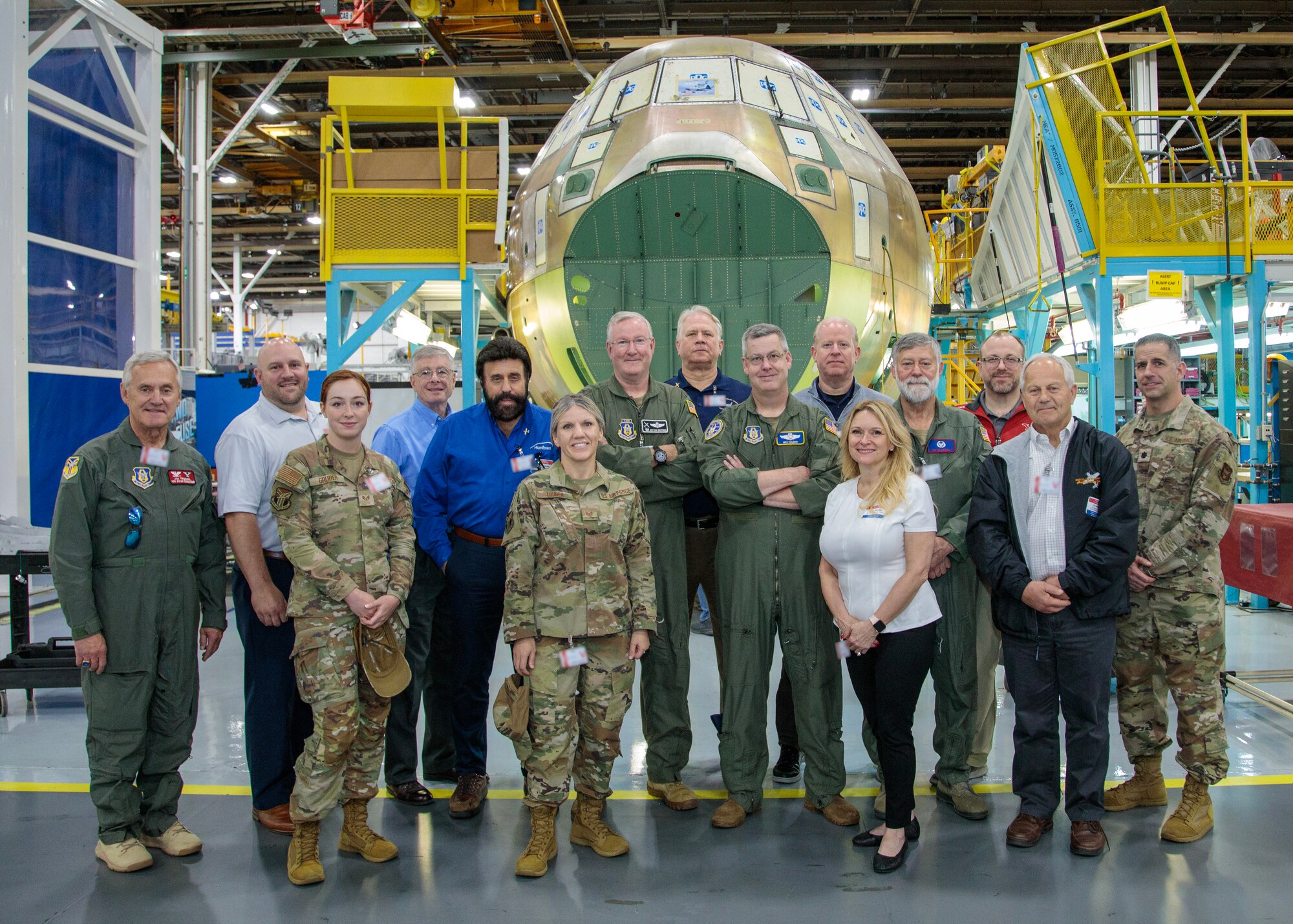 Participants in the 910th Airlift Wing’s civic leader tour to Dobbins Air Reserve Base, Georgia, pose for a photo in front of a new C-130J Super Hercules aircraft being built at the Lockheed-Martin plant, May 11, 2023.