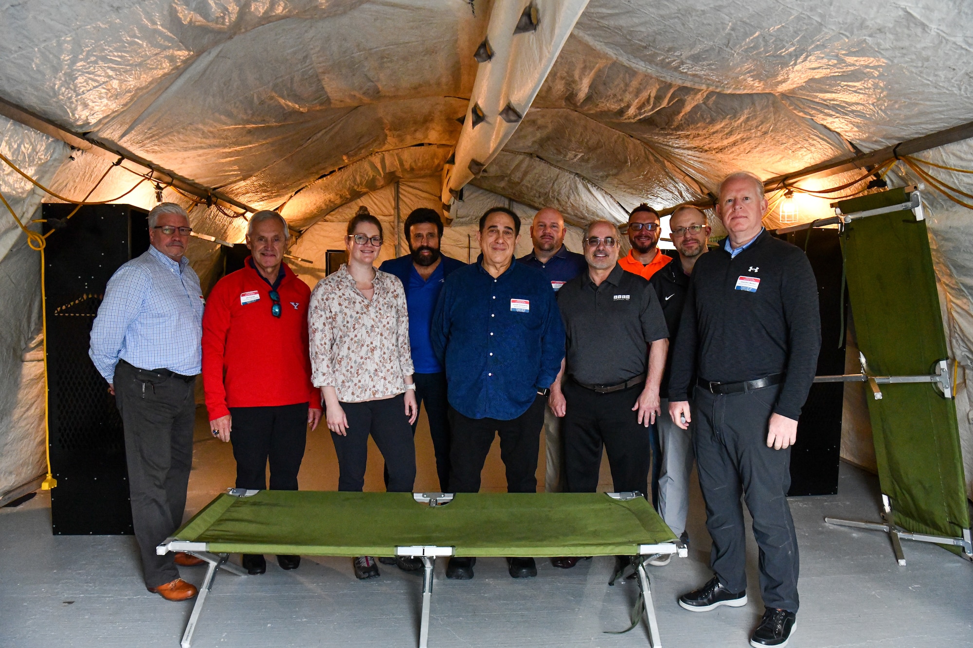 Participants in the 910th Airlift Wing’s civic leader tour to Dobbins Air Reserve Base, Georgia, pose for a photo in a tent used for lodging during military deployments at the Silver Flag facility, May 12, 2023.