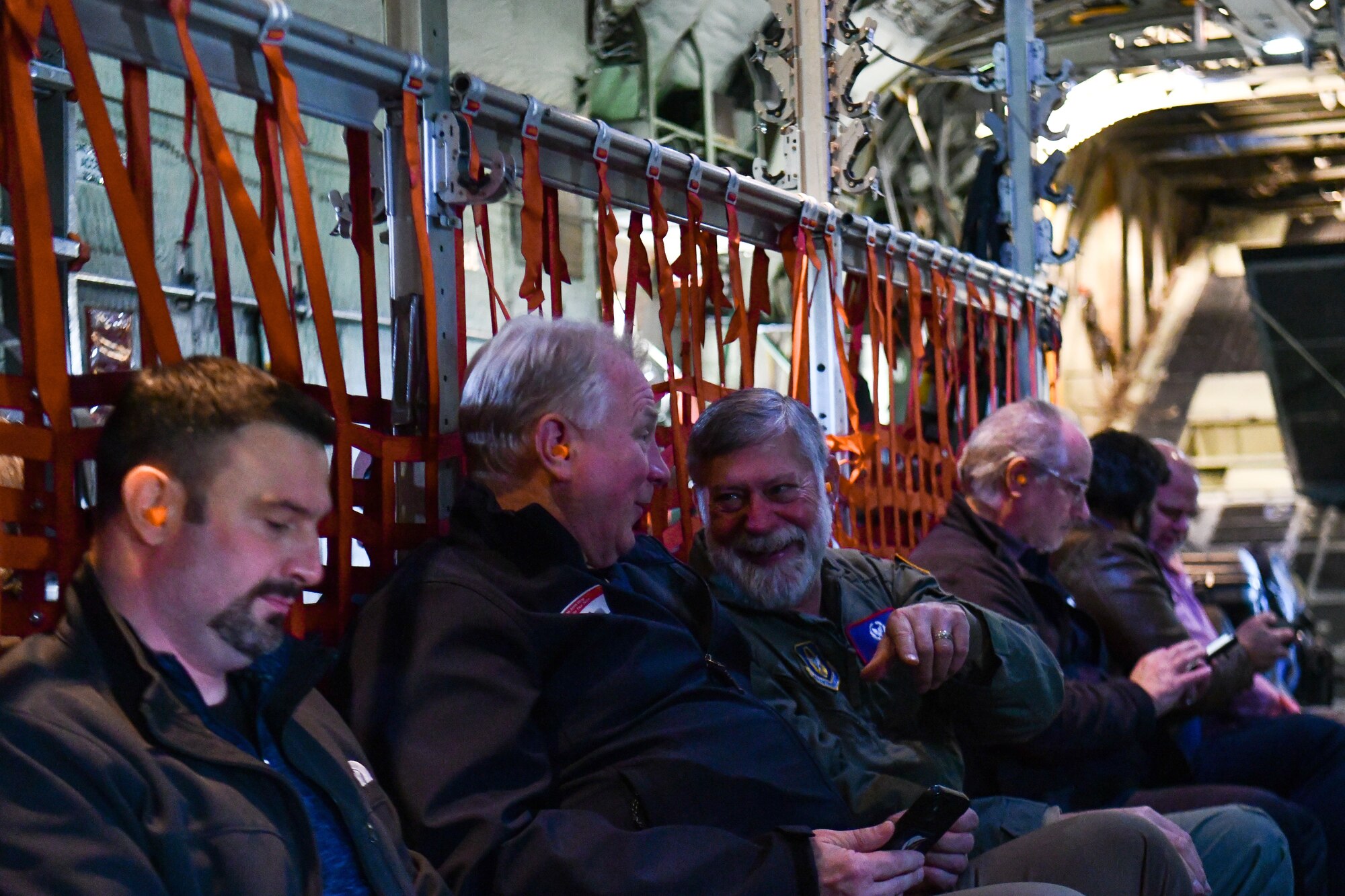 Participants in the 910th Airlift Wing’s civic leader tour to Dobbins Air Reserve Base, Georgia, discuss ideas during a C-130H Hercules aircraft flight, May 11, 2023.