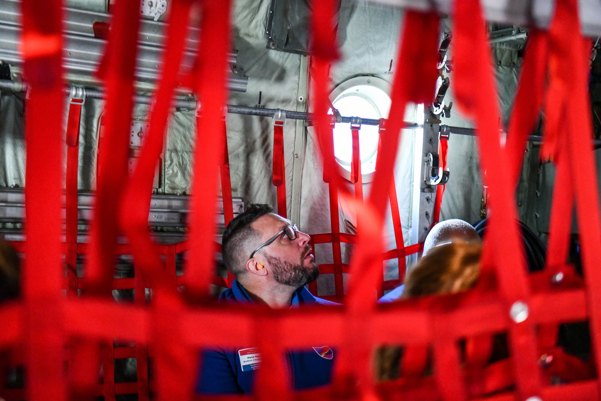 A participant in the 910th Airlift Wing’s civic leader tour to Dobbins Air Reserve Base, Georgia, looks around a C-130H Hercules aircraft during a flight, May 11, 2023.