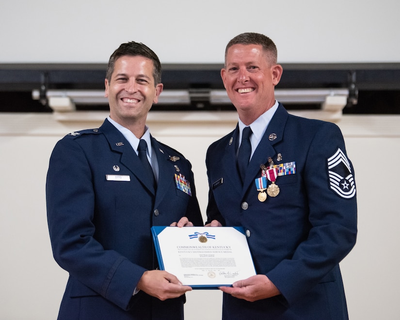 Chief Master Sgt. Kenneth Richards, right, senior enlisted leader of the 123rd Medical Group, receives the Kentucky Distinguished Service Medal from Col. Hans Otto, 123rd Medical Group commander, during Richards’ retirement ceremony at the Kentucky Air National Guard Base in Louisville, Ky., May 20, 2023. Richards is retiring after 30 years of service. (U.S. Air National Guard photo by Staff Sgt. Chloe Ochs)