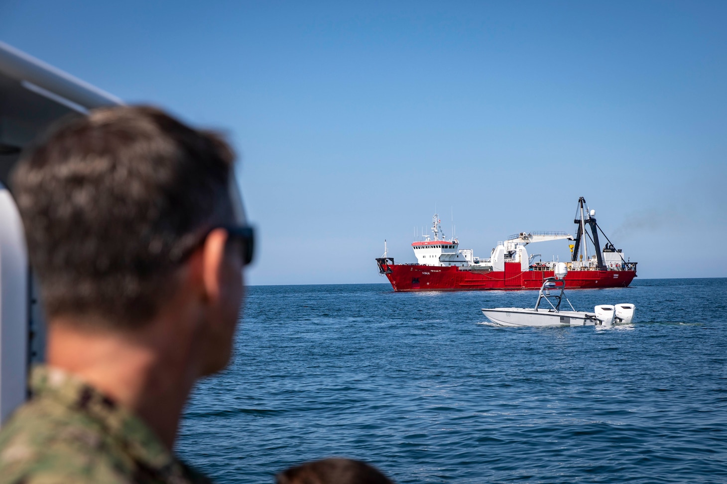 PUTLOS, Germany (June 6, 2023) Capt. Ryan Ventresca, commodore, Mine Countermeasures Group (MCMGRU) 3, observes a MARTAC T-24 unmanned surface vehicle (USV) during a demonstration as part of exercise Baltic Operations 2023 (BALTOPS 23). BALTOPS 23 is the premier maritime-focused exercise in the Baltic Region. The exercise, led by U.S. Naval Forces Europe-Africa, and executed by Naval Striking and Support Forces NATO, provides a unique training opportunity to strengthen combined response capabilities critical to preserving freedom of navigation and security in the Baltic Sea. (U.S Navy photo by Mass Communication Specialist 1st Class Matthew Fink)