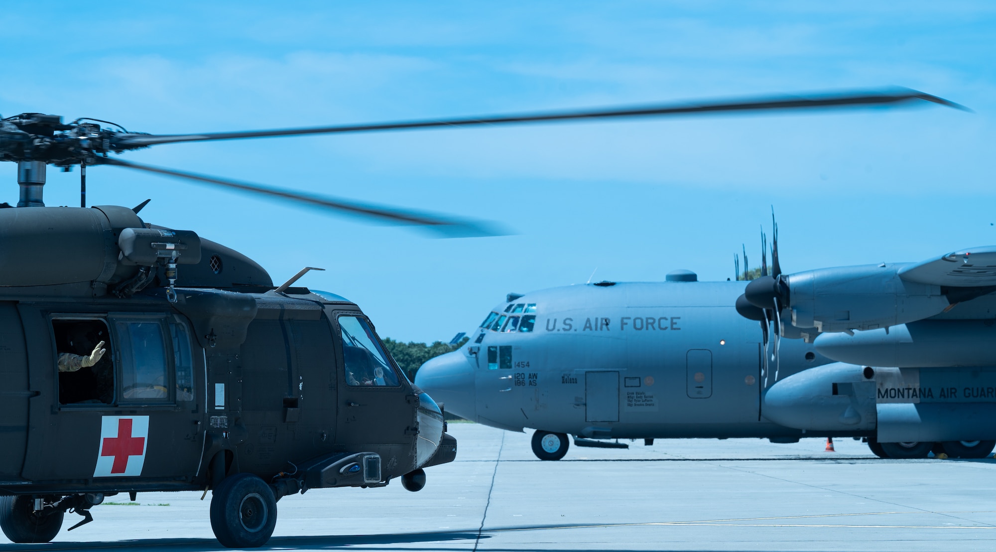 a helicopter sits on a ramp