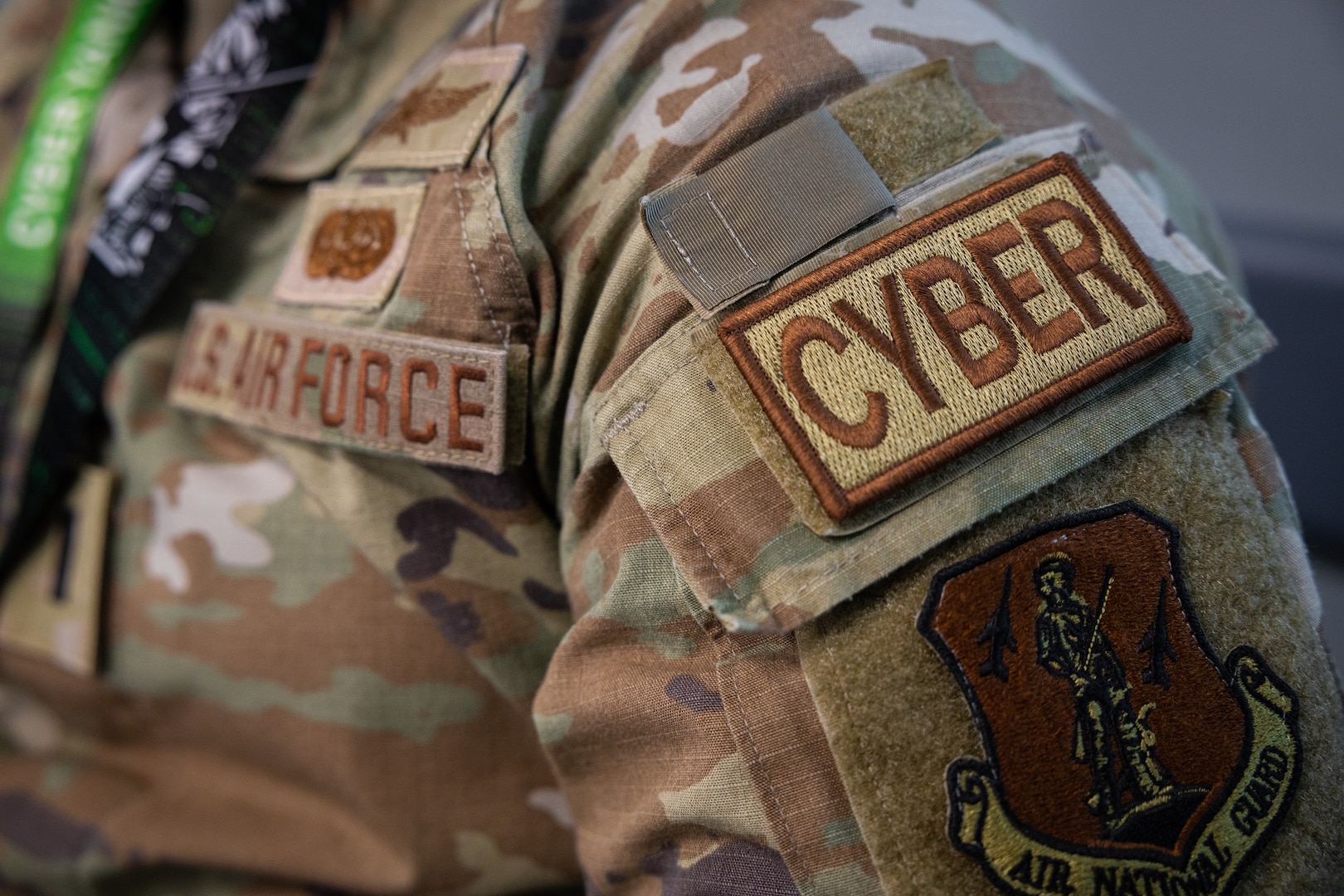 A cyber duty identifier patch is worn by U.S. Air Force 1st Lt. Gordon Smith, a cyberspace operations officer assigned to the 101st Air Refueling Wing, Maine Air National Guard, inside the Regional Training Institute at Camp Nett, Niantic, Connecticut, May 17, 2023. Duty identifier patches, also known as duty identifier tabs, are developed by the Institute of Heraldry and are used to easily differentiate the special skill sets of U.S. Air Force Airmen.