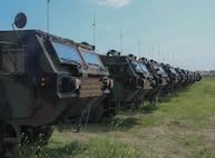 U.S. Army tactical vehicles from the 405th Army Field Support Battalion-Benelux stage with army prepositioned stock in support of Saber Guardian 23 at Mihail Kogalniceanu Air Base, Romania, May 19, 2023. Saber Guardian 23, a component of DEFENDER 23, is an exercise co-led by Romanian Land Forces and the U.S. Army at various locations in Romania to improve the integration of multinational combat forces by engaging in different events such as vehicle road marches, medical training exercises, and river crossings.