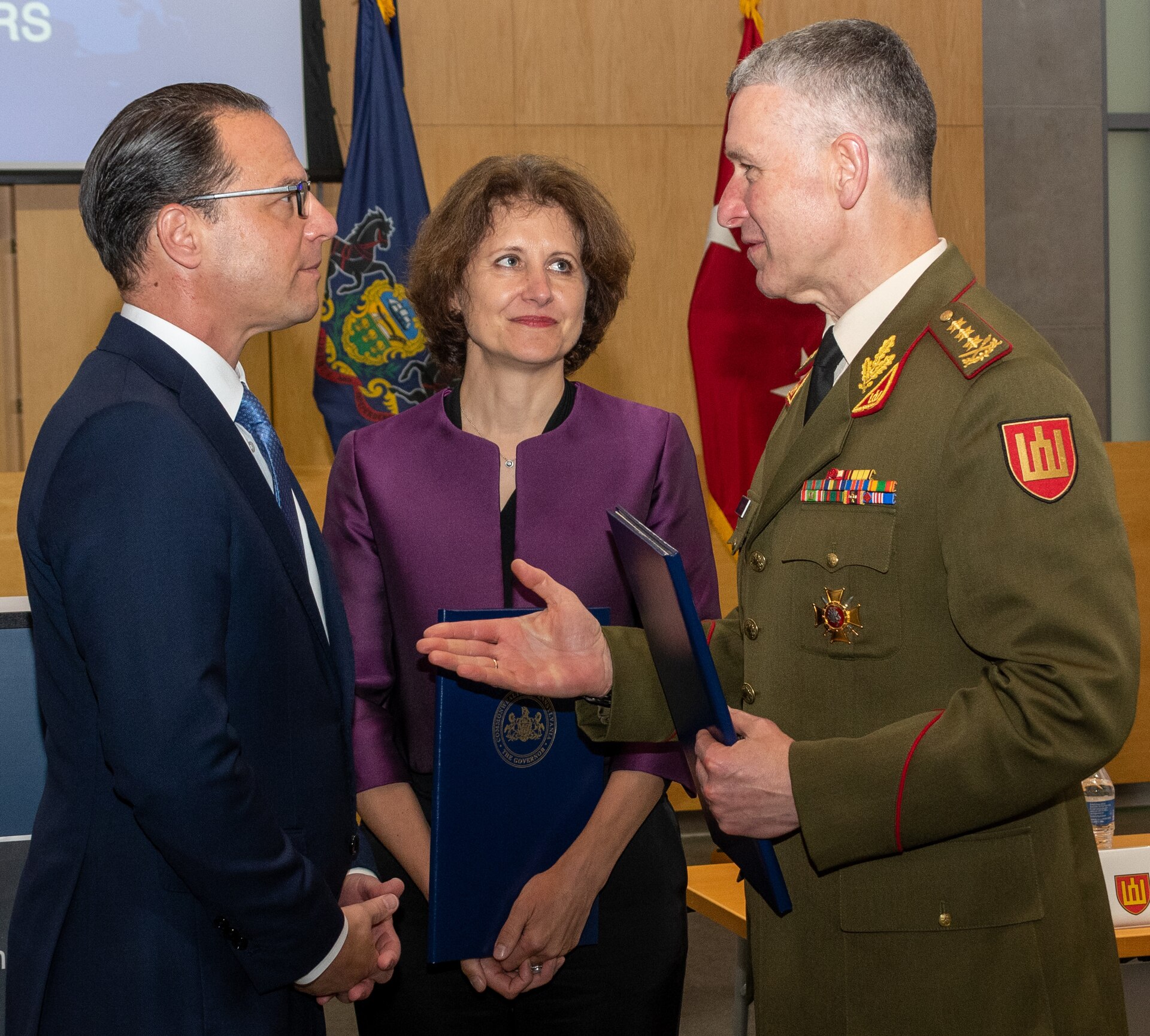 Left to right, Pennsylvania Gov. Josh Shapiro, Audra Plepytė, Lithuanian ambassador to the United States and Mexico, and Chief of Defense of the Republic of Lithuania Lt. Gen. Valdemaras Rupšys talk during a ceremony June 6 in Harrisburg to celebrate the 30-year anniversary of the partnership between the Pennsylvania National Guard and Lithuania. (Pennsylvania National Guard photo by Wayne V. Hall)